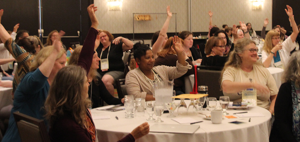 Midwives raising hands at AOM conference 2015