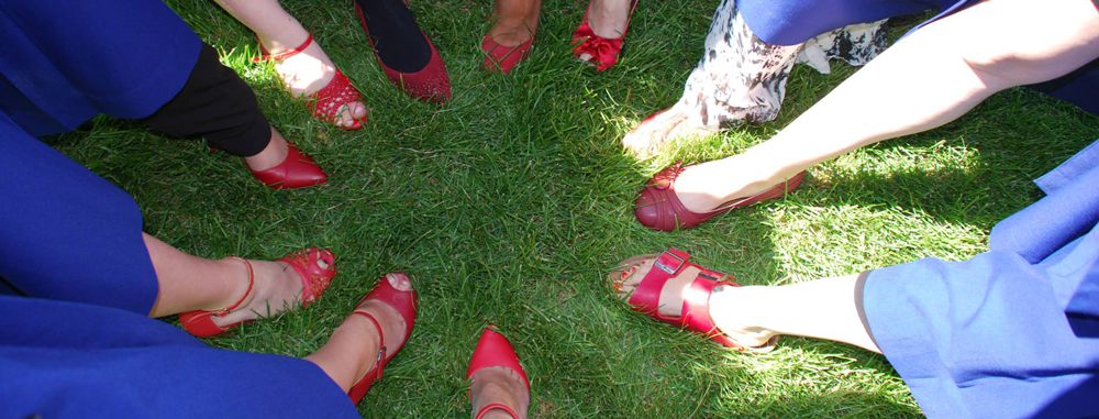 Midwifery students wearing red shoes at graduation